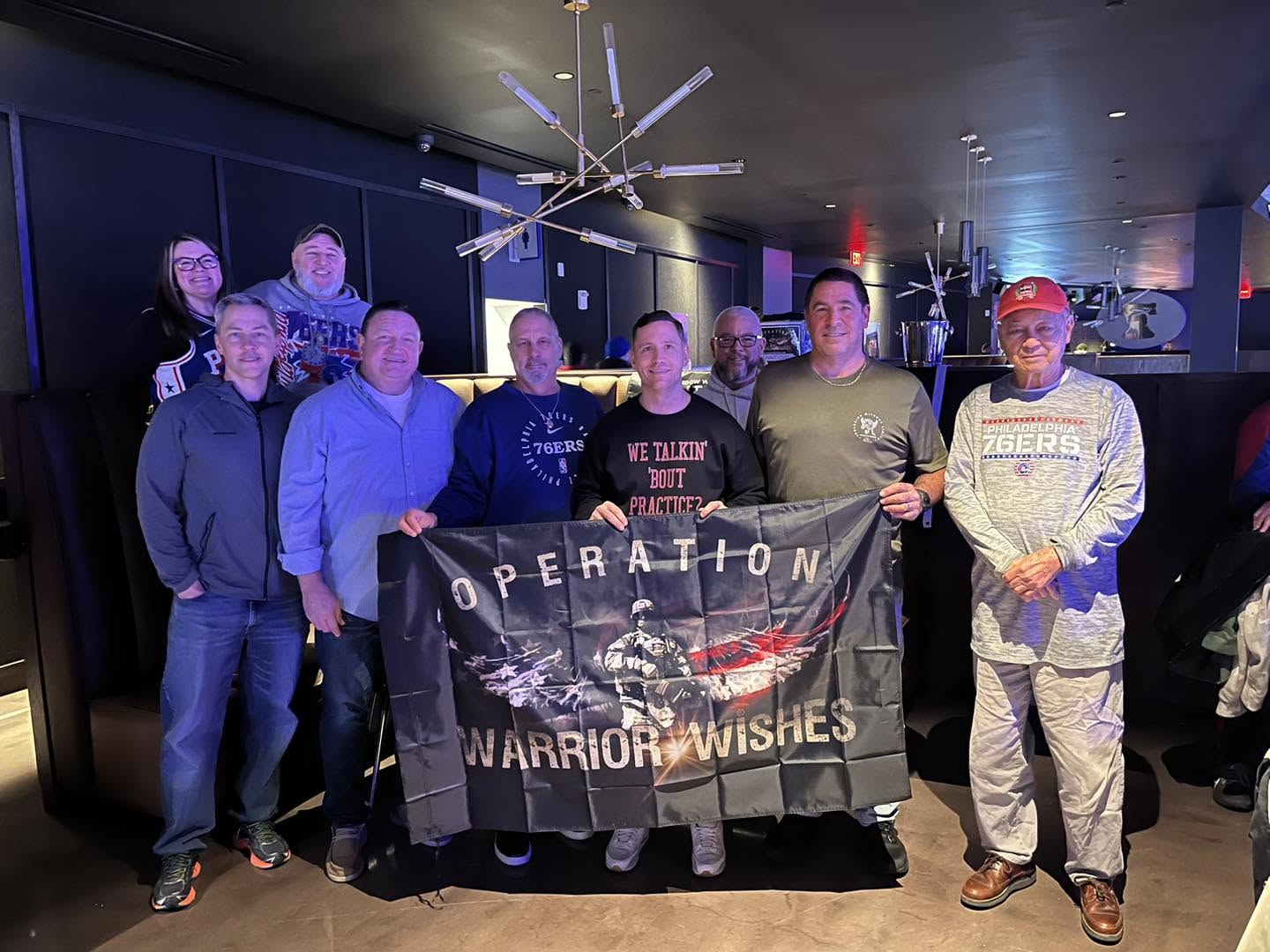 Warriors gathered in a 76ers suite for a Warrior Wishes game night