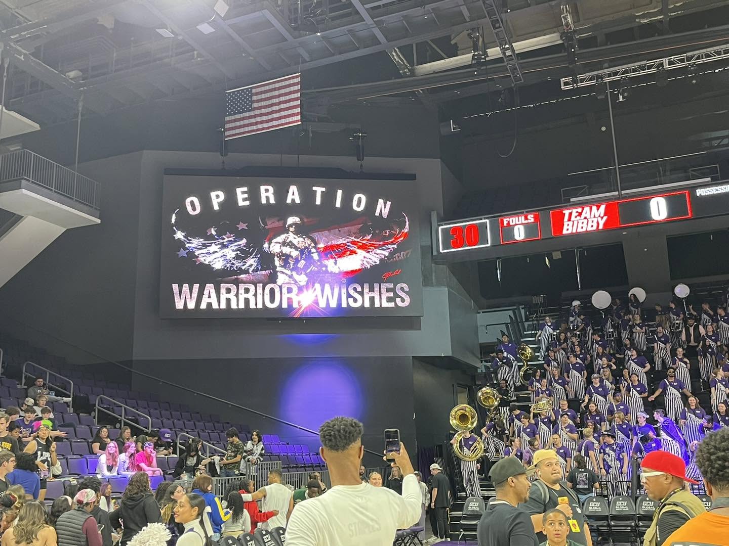 Operation Warrior Wishes tribute on the jumbotron at a college basketball game